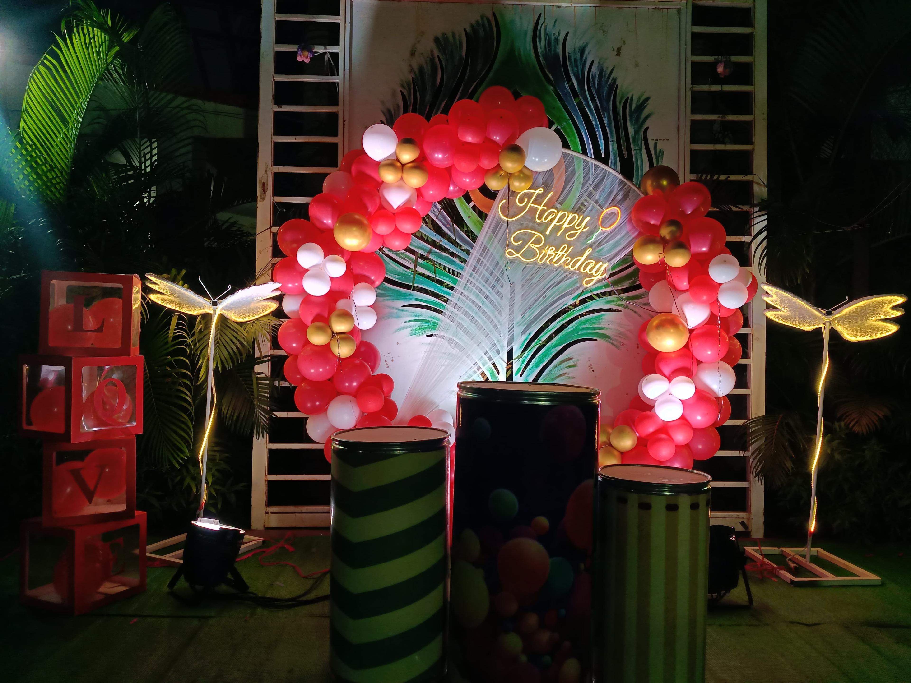 Festive birthday balloon arch, garden setting